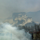 Smoke rises from burning buildings below the Potala Palace in the Tibetan capital Lhasa during protests on March 14, 2008.